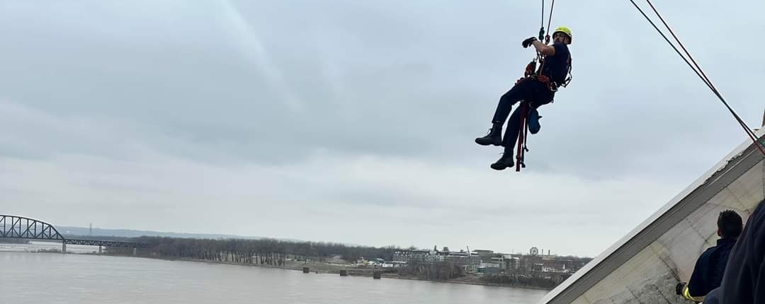 At around 12P.M. on Friday, March 1, 2024, rescue crews responded to a high-angle rescue on the Clark Memorial Bridge. They immediately assessed the scene and began rescue operations to save a semi-truck driver who was still in the cab of her truck hanging off the bridge over the Ohio River. Through their swift and proficient maneuvering, they safely rescued the victim in about 40 minutes.