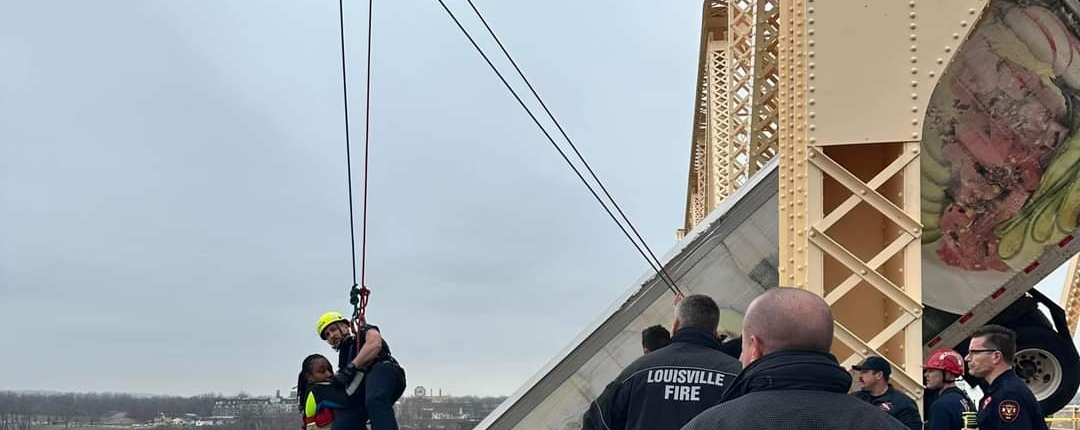 At around 12P.M. on Friday, March 1, 2024, rescue crews responded to a high-angle rescue on the Clark Memorial Bridge. They immediately assessed the scene and began rescue operations to save a semi-truck driver who was still in the cab of her truck hanging off the bridge over the Ohio River. Through their swift and proficient maneuvering, they safely rescued the victim in about 40 minutes.